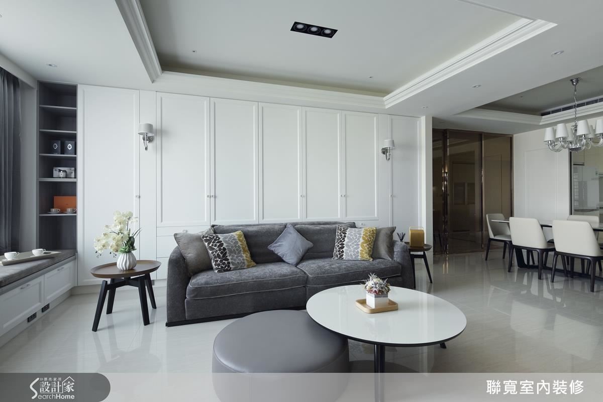 沿著動線來到客廳，薄片石材的灰與櫃體的白，營造空間層次，也讓色彩豐富的沙發成為空間的主角。在美式居家之中也融入王毓婷設計師擅長的現代俐落感。