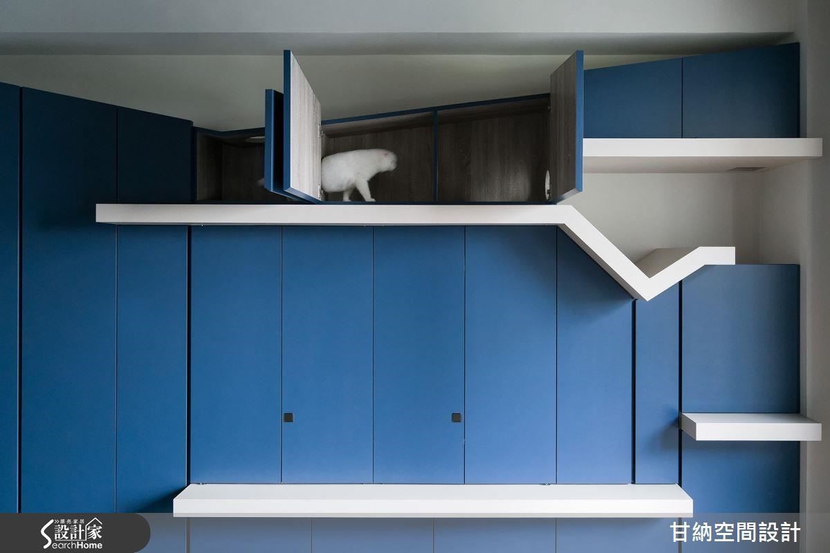 藍色收納的上方結合貓跳檯，讓貓咪得以悠閒的遊走在斜線切割的空間裡。