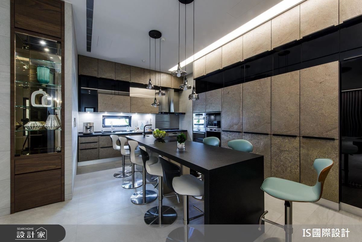 開放餐廚區以鑲嵌玻璃爐的黑色中島為軸心，背景同步高廚櫃整合家電收納，外觀搭配金砂岩面板，以及刻意內退處理的黑色烤玻，將造型層次拉高並軟化櫃體存在感，也是親朋好友最愛的交誼中心。