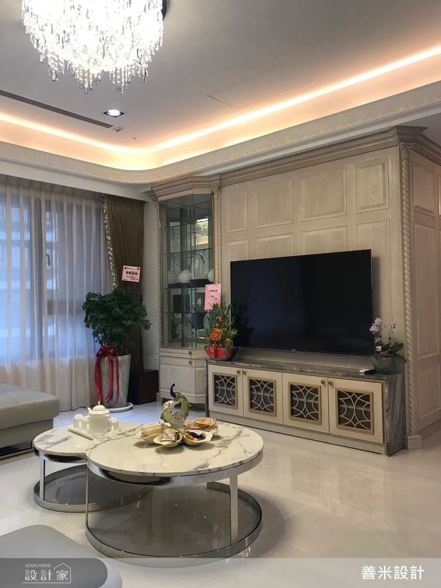 客廳電視櫃以大理石與金屬飾條的交織手法創造絕佳視覺造型，一旁透明展示櫃還可陳列屋主的精緻收藏，精確掌握機能美感。