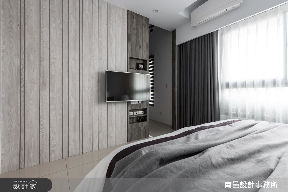 主臥室床頭牆面使用藕灰色調，輕柔舒緩睡眠氛圍，並以異材質搭配電視牆面，呈現豐富視覺層次。