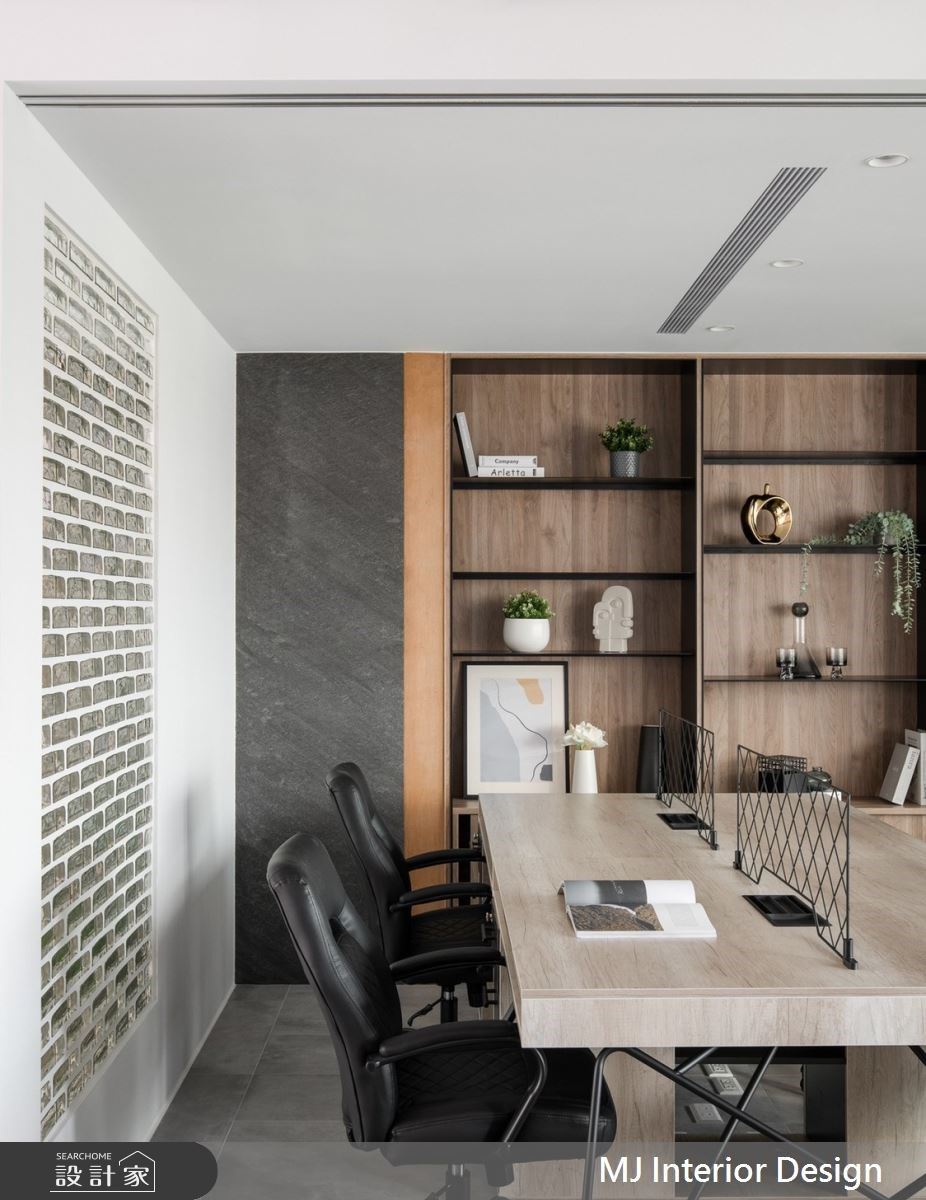 員工辦公區設置異材結合的整面書櫃，除收納機能外也充滿設計感，員工區與總監辦公室的隔間牆以玻璃磚引入光線。