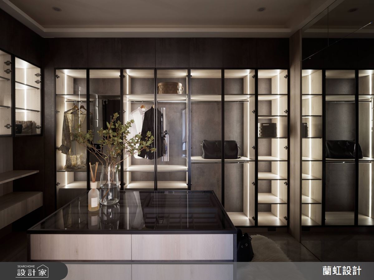 主臥更衣室以精品店概念打造，中島首飾櫃及深色玻璃櫃，搭配光氛設計，呈現高質感的更衣間。