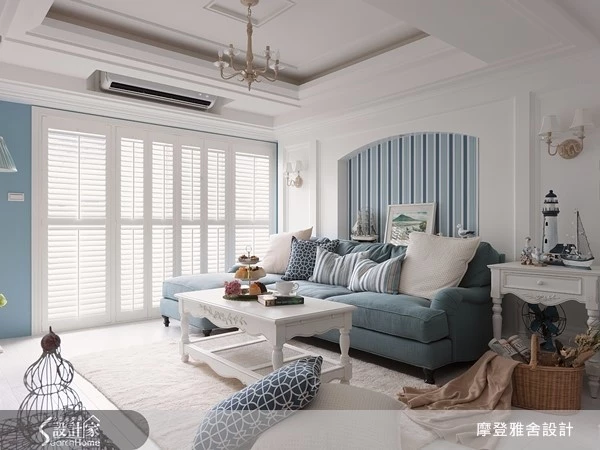 利用純白色系調和皇家藍，將重點放在部分牆面油漆與軟件佈置，最後在沙發背牆使用深淺交替的藍色壁紙，讓設計質感立現。